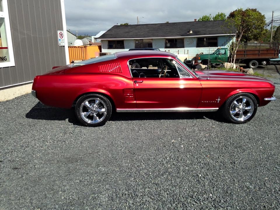 Candy-red 1967 Mustang fastback with a custom refinish
