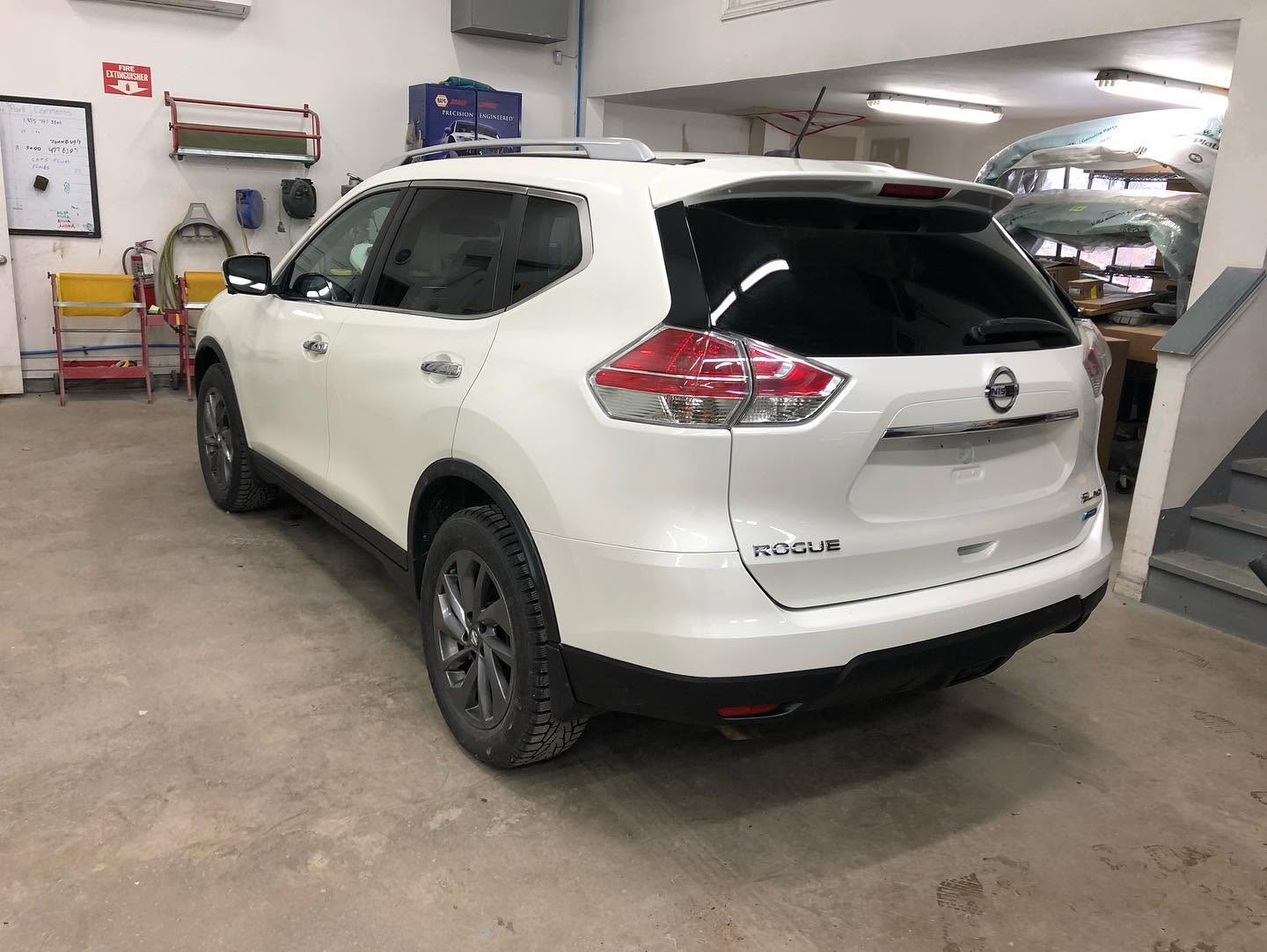 White Nissan Rogue with a replaced and repainted rear quarter